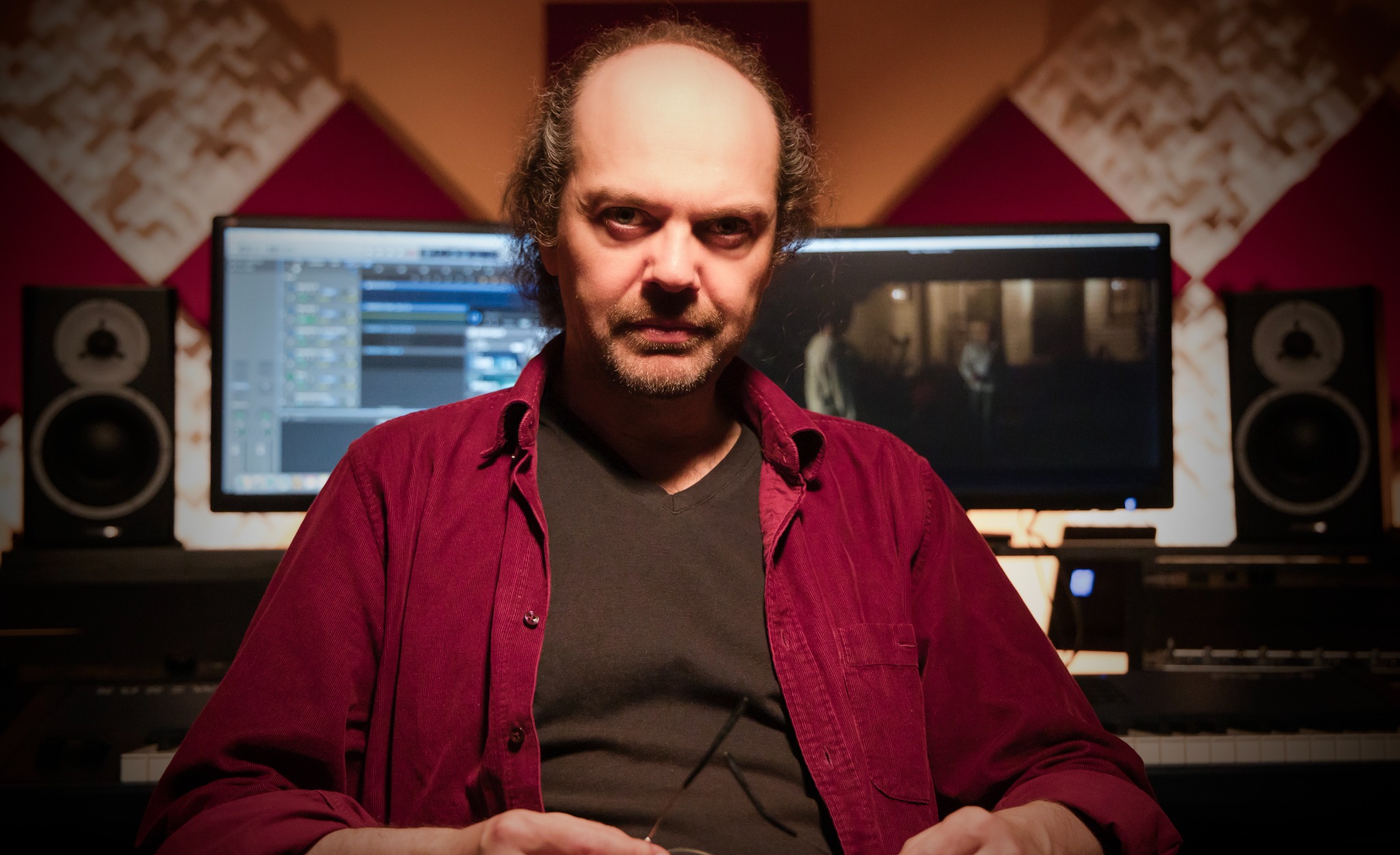 Octavio Vázquez in his studio, with recording monitors and speakers behind him
